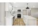 Bright kitchen with white cabinets, a central island, and stainless steel appliances at 109 Riverbend Dr, Archer Lodge, NC 27527