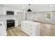 Charming kitchen featuring white cabinets, a large island, and stainless steel appliances at 109 Riverbend Dr, Archer Lodge, NC 27527