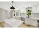Light and airy kitchen features white cabinets, an island, and stainless steel appliances at 109 Riverbend Dr, Archer Lodge, NC 27527