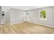 Cozy living room with bright and neutral paint, a modern front door, and hardwood floors at 109 Riverbend Dr, Archer Lodge, NC 27527
