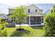 This backyard features green grass, a patio, a fire pit, and a screened-in porch attached to a home at 1102 Birchbark Rd, Durham, NC 27705
