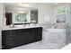 This bathroom features a double sink vanity, soaking tub, and glass shower at 1102 Birchbark Rd, Durham, NC 27705