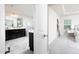 Open door reveals luxurious bathroom with soaking tub, double vanity, and elegant finishes at 1102 Birchbark Rd, Durham, NC 27705
