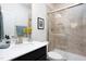 This bathroom has a tiled glass shower and vanity with a white countertop and modern fixtures at 1102 Birchbark Rd, Durham, NC 27705