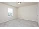 This bedroom has carpet flooring and a window at 1102 Birchbark Rd, Durham, NC 27705