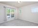 The bedroom has neutral walls and carpeting, and multiple windows that provide natural light and exterior views at 1102 Birchbark Rd, Durham, NC 27705