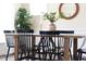 Bright dining room with hardwood floors, black chairs, chandelier, and round mirror above the table at 1102 Birchbark Rd, Durham, NC 27705