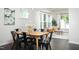 Inviting dining area with hardwood floors, contemporary lighting, and an adjoining living area at 1102 Birchbark Rd, Durham, NC 27705