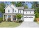Charming two-story home featuring a two-car garage and a beautifully landscaped front yard at 1102 Birchbark Rd, Durham, NC 27705