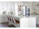 Modern eat-in kitchen with white cabinets, granite countertops, stainless appliances and pendant lights at 1102 Birchbark Rd, Durham, NC 27705