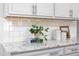 Granite countertops and white subway tile backsplash adorn the gourmet kitchen at 1102 Birchbark Rd, Durham, NC 27705