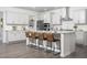 Gourmet kitchen with white cabinetry, granite countertops, and bar seating at the island at 1102 Birchbark Rd, Durham, NC 27705
