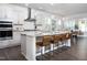 Bright modern kitchen with a white island, white cabinetry, granite countertops, and stainless steel appliances at 1102 Birchbark Rd, Durham, NC 27705