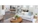 Open-concept living room with a cozy seating area and a view of the modern kitchen at 1102 Birchbark Rd, Durham, NC 27705