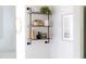 Charming wood and pipe shelving, nicely decorated, next to a wall outlet at 1102 Birchbark Rd, Durham, NC 27705