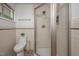 Well-lit bathroom featuring a glass-enclosed shower and a decorative plant on the toilet at 1111 Sourwood Cir, Chapel Hill, NC 27517