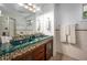 Bathroom featuring double sinks with a mosaic tile countertop, a large mirror, and tile flooring at 1111 Sourwood Cir, Chapel Hill, NC 27517