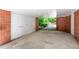 Under-house carport area with enclosed storage at 1111 Sourwood Cir, Chapel Hill, NC 27517