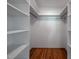 Open, empty closet with hardwood floors and shelving at 1111 Sourwood Cir, Chapel Hill, NC 27517