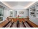 View of the dining area from the living room, featuring wood floors and custom built-in shelving at 1111 Sourwood Cir, Chapel Hill, NC 27517