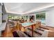 Bright dining area with an updated table and views of the backyard pool and patio at 1111 Sourwood Cir, Chapel Hill, NC 27517