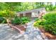 Attractive single-story home with walkway and beautiful landscaping at 1111 Sourwood Cir, Chapel Hill, NC 27517