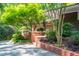 Close up of the front entrance with brick lined walkway and lush landscaping at 1111 Sourwood Cir, Chapel Hill, NC 27517