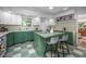 Unique kitchen with a center island, white cabinetry, and a checkered floor at 1111 Sourwood Cir, Chapel Hill, NC 27517