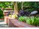 Manicured landscaping with brick border and decorative plants at 1111 Sourwood Cir, Chapel Hill, NC 27517