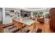 Open floorplan featuring hardwood floors, a dining area, and a living room with a brick fireplace at 1111 Sourwood Cir, Chapel Hill, NC 27517