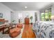 Main bedroom with hardwood floors, a sitting area, and access to a private balcony at 1111 Sourwood Cir, Chapel Hill, NC 27517