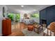 Main bedroom featuring a blue brick fireplace, hardwood floors, and a sliding glass door to a private balcony at 1111 Sourwood Cir, Chapel Hill, NC 27517