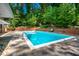 Inviting backyard pool area offering mature trees and lounge area at 1111 Sourwood Cir, Chapel Hill, NC 27517
