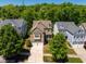 Beautiful suburban home featuring a two-car garage, mature trees, and well-maintained landscaping at 113 Ruskin Dr, Chapel Hill, NC 27516
