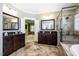 Spacious bathroom showcasing a double vanity, a glass enclosed shower and a soaking tub at 113 Ruskin Dr, Chapel Hill, NC 27516