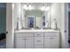 This bathroom includes a double sink vanity with white cabinets and hardware, along with modern lighting at 113 Ruskin Dr, Chapel Hill, NC 27516