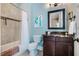 Cozy bathroom featuring a shower-tub combination, marble countertop vanity, and modern fixtures at 113 Ruskin Dr, Chapel Hill, NC 27516