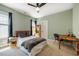 Comfortable bedroom featuring a ceiling fan, large bed with gray bedding, and a colorful desk at 113 Ruskin Dr, Chapel Hill, NC 27516