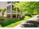 Exterior of multi-story condos with private patios & landscaped grounds, accessible to paved walking path at 113 Ruskin Dr, Chapel Hill, NC 27516