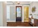 Elegant foyer featuring hardwood floors, stylish console table, and a modern light fixture at 113 Ruskin Dr, Chapel Hill, NC 27516