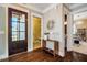 Inviting foyer with hardwood floors, decorative mirror, and seamless transitions to other rooms at 113 Ruskin Dr, Chapel Hill, NC 27516