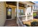 Cozy front porch with brick flooring, white railings, and a view of the neighborhood at 113 Ruskin Dr, Chapel Hill, NC 27516