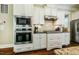 Modern kitchen with stainless steel appliances, white cabinetry, and a tile backsplash at 113 Ruskin Dr, Chapel Hill, NC 27516