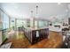 Open-concept kitchen featuring an island with pendant lighting and views into the living and dining spaces at 113 Ruskin Dr, Chapel Hill, NC 27516
