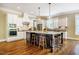 Bright kitchen with a large center island, hardwood floors, stainless appliances, and pendant lighting at 113 Ruskin Dr, Chapel Hill, NC 27516