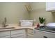 This laundry room features ample countertop space, a sink, storage cabinets, and a modern washer and dryer at 113 Ruskin Dr, Chapel Hill, NC 27516