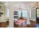 Open-concept space with pillars, wainscotting, and a decorative chandelier over a rug-covered sitting area at 113 Ruskin Dr, Chapel Hill, NC 27516