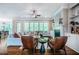 Spacious living room featuring a large sofa, fireplace, and plenty of natural light from large windows at 113 Ruskin Dr, Chapel Hill, NC 27516