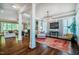 Bright living room features dark wood floors, columns, and an adjacent seating area with large windows at 113 Ruskin Dr, Chapel Hill, NC 27516