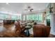 Open concept living room with dark wood floors, bright natural light, and access to the kitchen at 113 Ruskin Dr, Chapel Hill, NC 27516